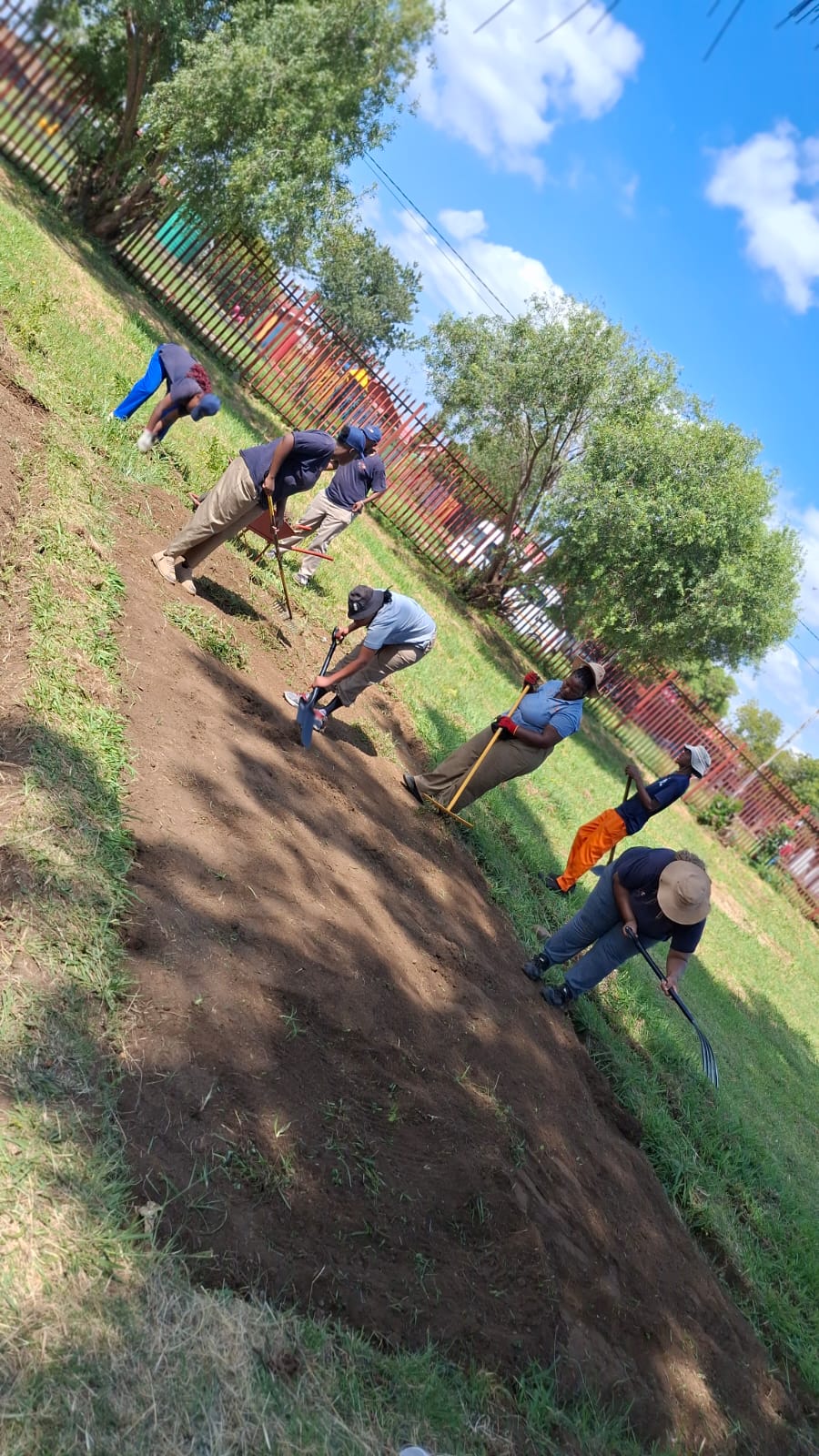 Programme participants preparing garden beds for planting