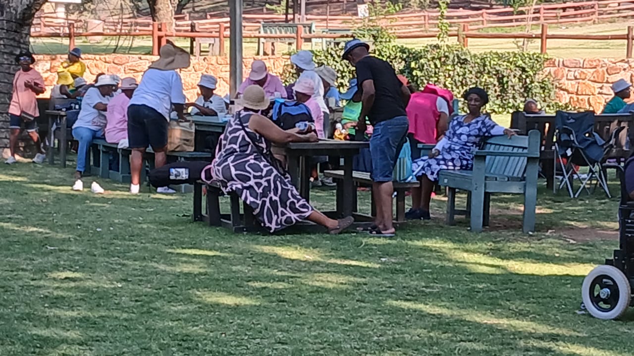 Senior citizens gathered outdoors at a community event