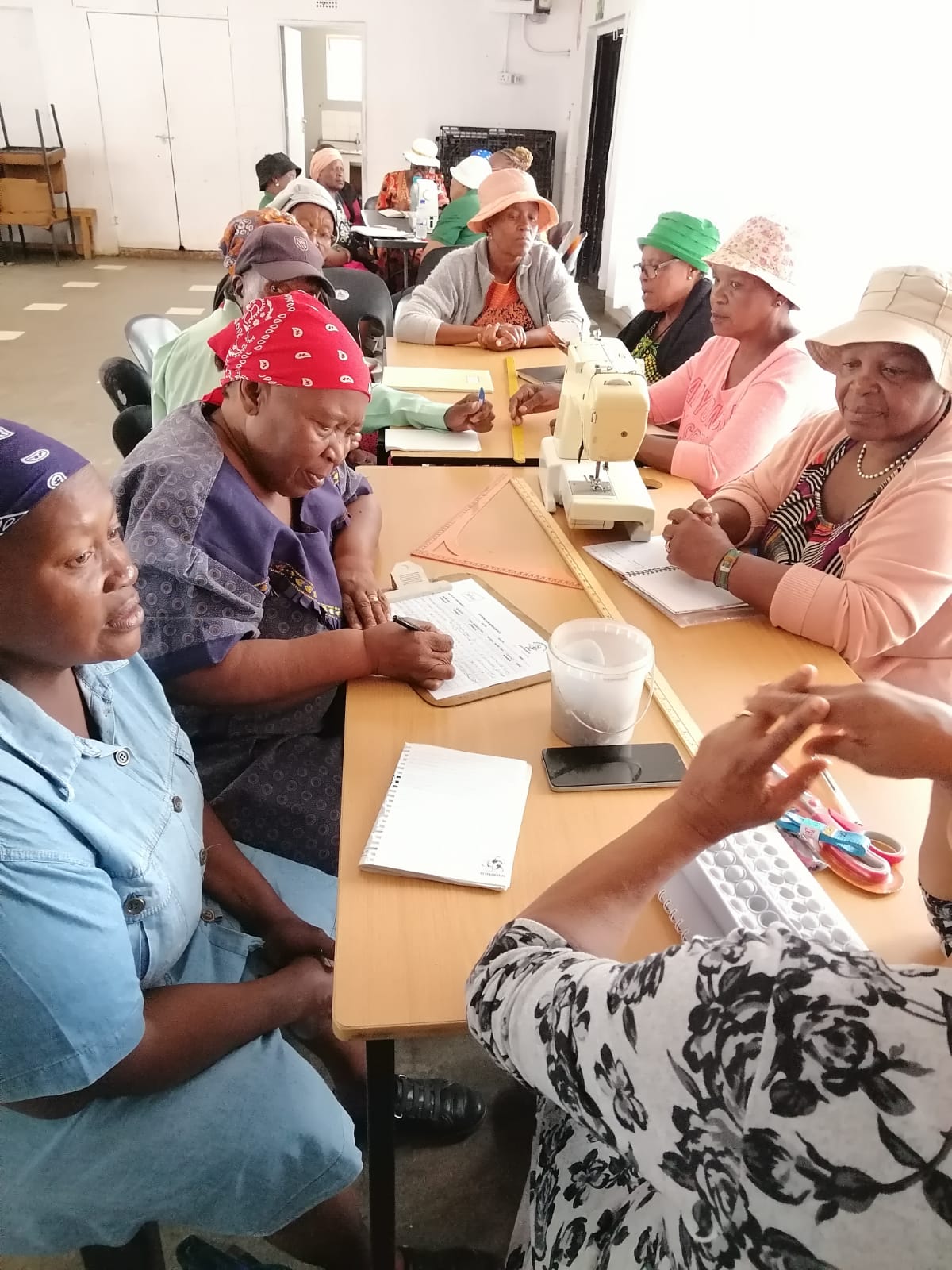Community members attending a sewing and skills development class at the centre