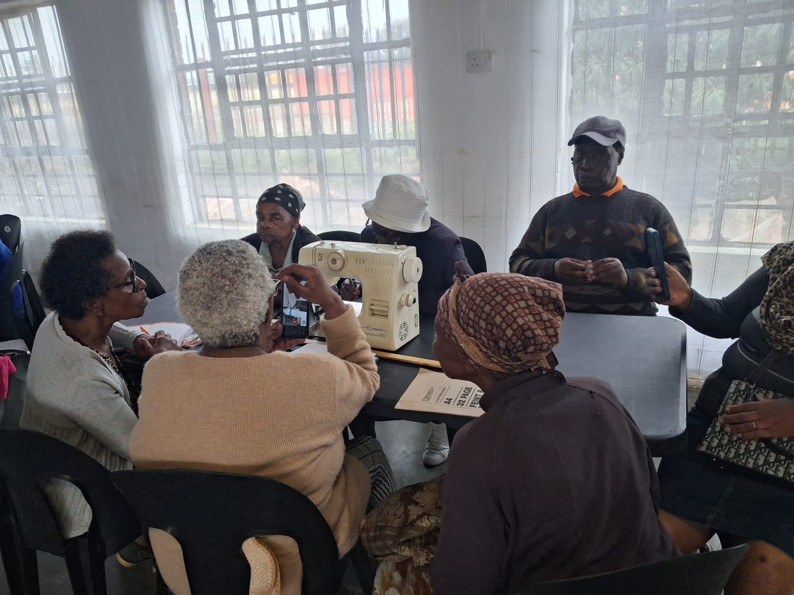 Community members seated together during a programme session