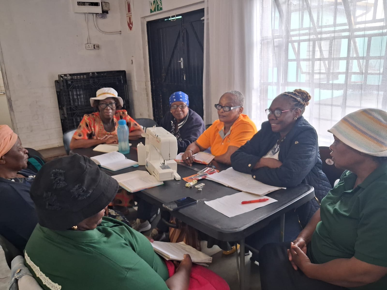 Facilitators and community members in a planning session at the centre