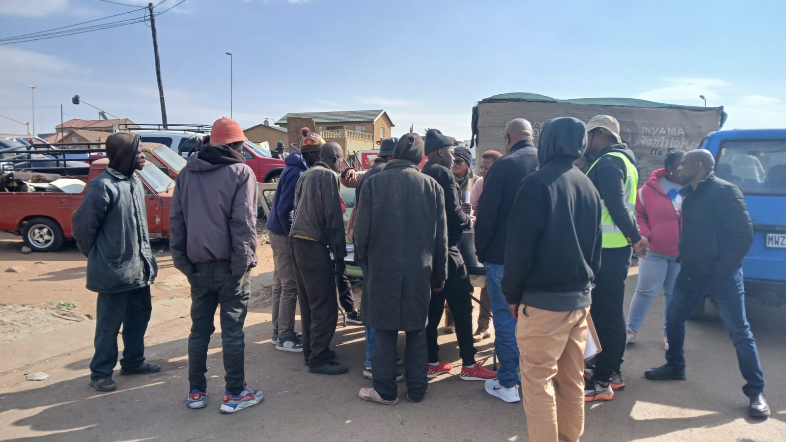 Community outreach workers engaging with residents during a substance abuse awareness drive